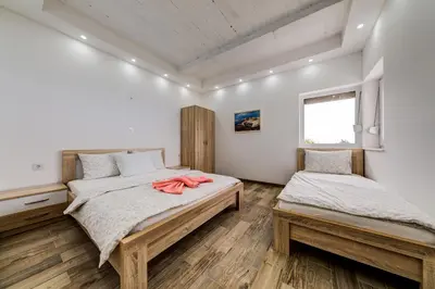 a bedroom with two beds and a window at Villas Adriatic Horizonte in Budva
