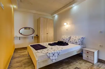 a small bedroom with a bed and a mirror at Villas Adriatic Horizonte in Budva