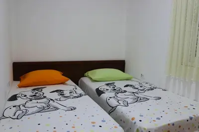 two beds in a room with pugs on them at IdealHouse Apartments in Ulcinj
