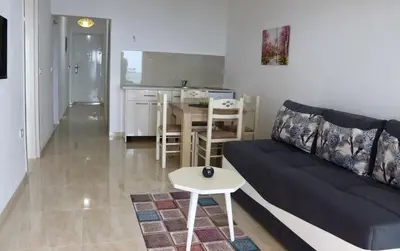 a living room with a couch and a table at IdealHouse Apartments in Ulcinj