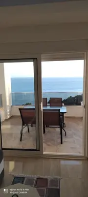 a living room with a view of the ocean at IdealHouse Apartments in Ulcinj