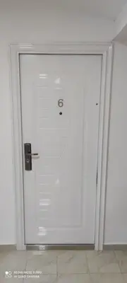 a large white door in a white room at IdealHouse Apartments in Ulcinj