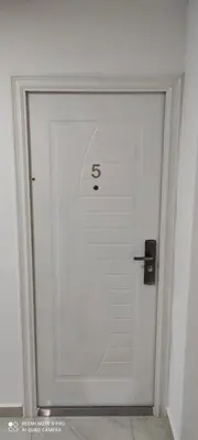 a white door with the number on it at IdealHouse Apartments in Ulcinj