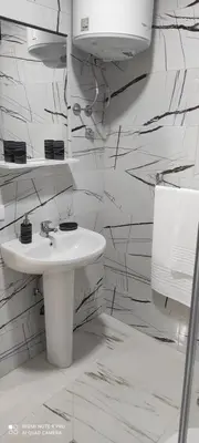 a white bathroom with a sink and a mirror at IdealHouse Apartments in Ulcinj