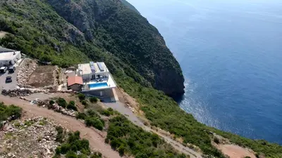 an aerial view of a house on a hill next to the water at Villa Nerin in Zagora
