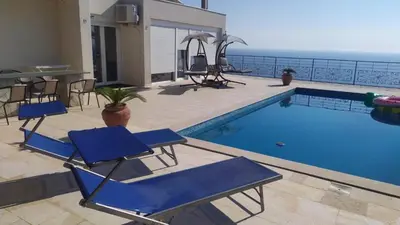 a patio with chairs and a swimming pool at Villa Nerin in Zagora