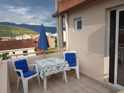a table and two chairs on a balcony at Apartments Vila Galileo in Budva