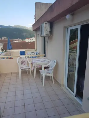a patio with a table and chairs on a balcony at Apartments Vila Galileo in Budva