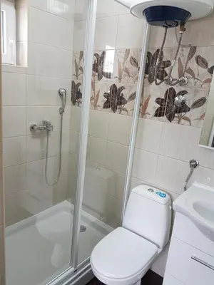 a bathroom with a shower and a toilet and a sink at Apartments Vila Galileo in Budva