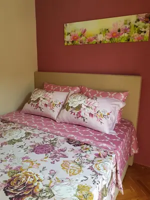 a bed with two pillows on top of it at Apartments Vila Galileo in Budva