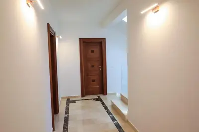 a hallway with a door and a tile floor at Villa Horus in Sveti Stefan