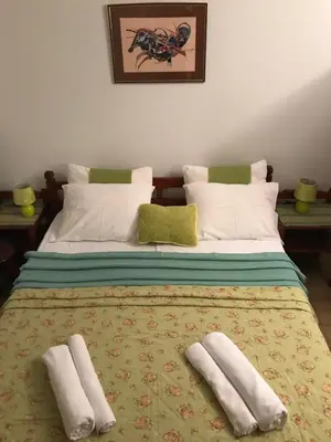 a bed with two pillows on top of it at Miron apart&rooms in Rafailovici