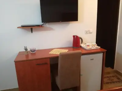 a desk with a television on top of a wall at Miron apart&rooms in Rafailovici