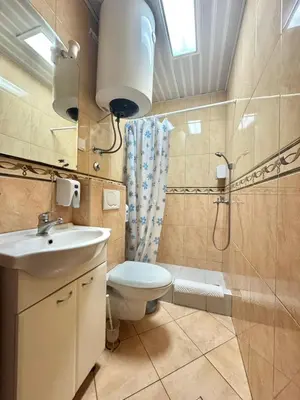 a bathroom with a toilet and a sink and a shower at Contessa Apartments in Budva