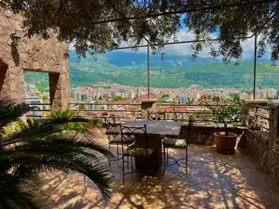 a table and chairs on a balcony with a view at Contessa Apartments in Budva