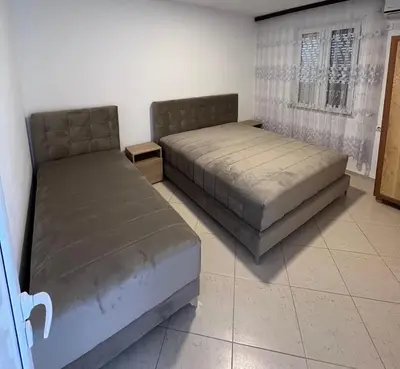 a bedroom with two beds and a window at Apartments Beho in Ulcinj
