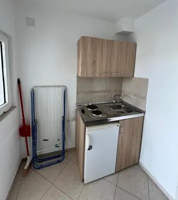 a small kitchen with a stove and a refrigerator at Apartments Beho in Ulcinj