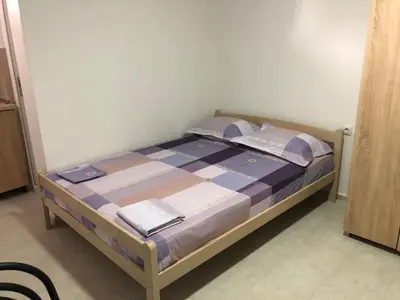 a bedroom with a bed with a blue and white comforter at Apartments Beho in Ulcinj
