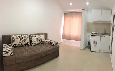 a living room with a couch and a kitchen at Apartments Beho in Ulcinj