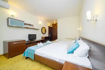 a hotel room with a bed and a television at Hotel Odissey Jaz in Budva