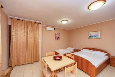 a small room with a bed and a table at Villa Glavanovic in Bar