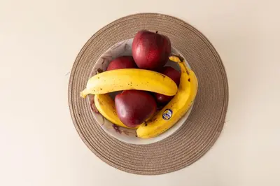 a bowl of fruit with bananas and apples in it at Apartmani Marojević, Bar in Bar