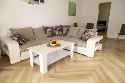 a living room with a couch and a table at Apartmani Marojević, Bar in Bar