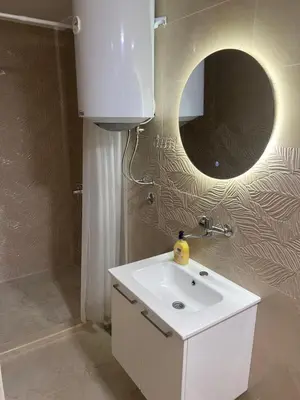 a bathroom with a white sink and a mirror at Apartmani Marojević, Bar in Bar