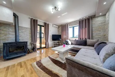 a living room with a couch and a fireplace at Alt Braic Villa in Budva