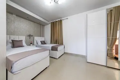 a bedroom with two beds and a window at Alt Braic Villa in Budva