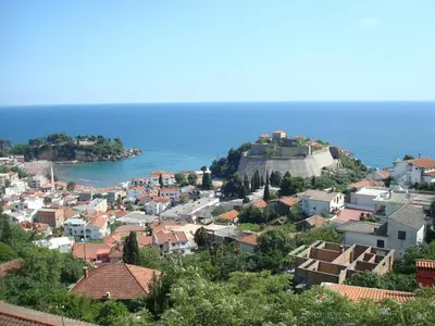a town on a hill with the ocean in the background at Apartments Cejovic in Ulcinj