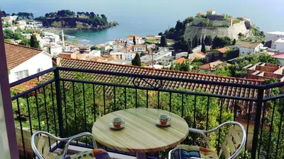a table on a balcony with a view of the ocean at Apartments Cejovic in Ulcinj