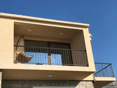 a balcony of a house with a chicken on it at Loft Infinity in Petrovac na Moru