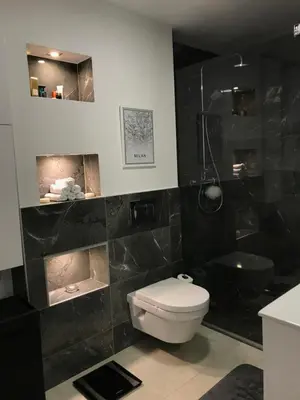 a black bathroom with a toilet and a shower at Loft Infinity in Petrovac na Moru