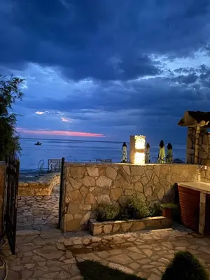 a stone wall with a view of the ocean at Loft Infinity in Petrovac na Moru