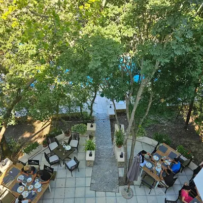 an overhead view of a patio with tables and chairs at Green Hill Apartments in Ulcinj