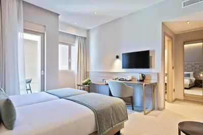 a hotel room with a bed and a desk at Hotel AMI Budva Petrovac in Petrovac na Moru