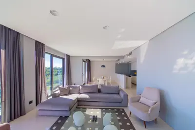 a living room with a couch and two chairs at Villas Vita & Dola in Budva