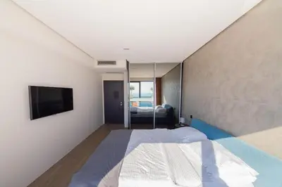 a bedroom with a bed and a flat screen tv at Villas Vita & Dola in Budva