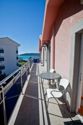 a patio with a table and chairs on a balcony at Apartments Stefan in Becici