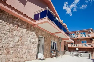 a building with a balcony on top of it at Apartments Stefan in Becici