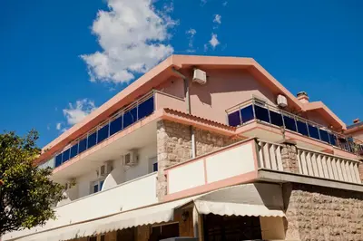 a building with a balcony on top of it at Apartments Stefan in Becici