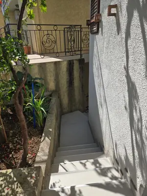 a set of stairs leading up to a house at Apartmani Vitic in Bar