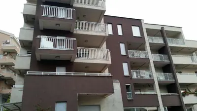 a tall building with balconies on the side of it at Dvosoban stan, Babin Do, Budva sa garazom in Budva