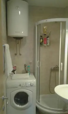 a bathroom with a washing machine and a shower at Dvosoban stan, Babin Do, Budva sa garazom in Budva