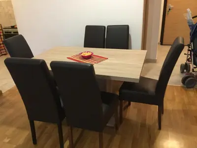 a dining room table with black chairs and a wooden table at Dvosoban stan, Babin Do, Budva sa garazom in Budva