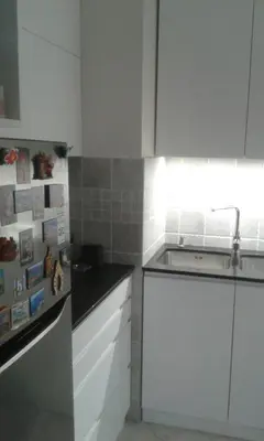 a kitchen with white cabinets and a counter top at Dvosoban stan, Babin Do, Budva sa garazom in Budva
