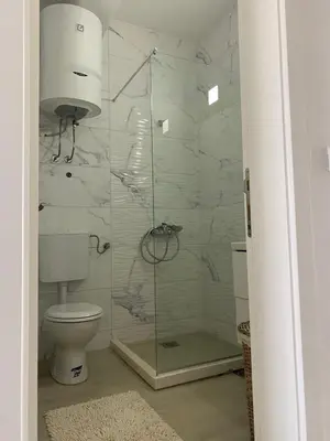 a bathroom with a toilet and a glass shower at Rasi Luxury Apartments in Ulcinj