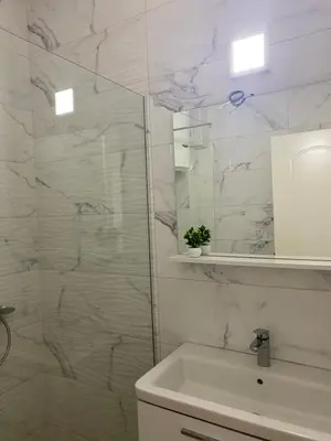 a white bathroom with a sink and a mirror at Rasi Luxury Apartments in Ulcinj
