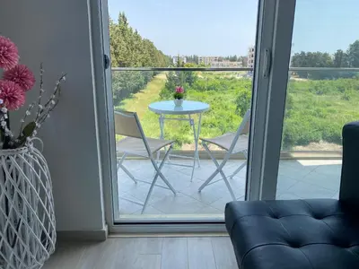 a patio with a table and chairs on a balcony at Rasi Luxury Apartments in Ulcinj